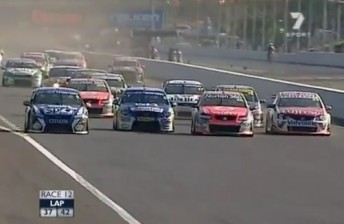 thumb The calm before the storm – the V8 field roar four wide into turn one.