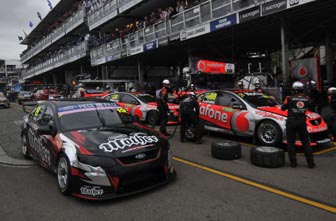 thumb Jonathon Webb passes the TeamVodafone Commodores at Sydney. Next year, Webb will be driving a Triple Eight-built Holden