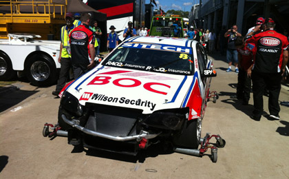 thumb Bright's car behind the pit garages after its accident