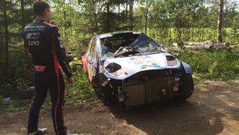 Paddon looks at his heavily damaged Hyundai