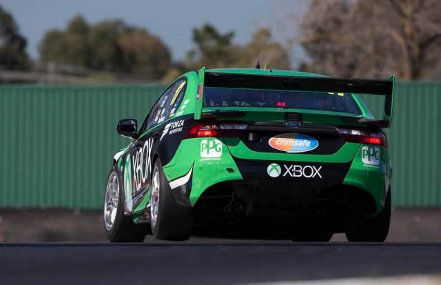 The DJR Team Penske Ford lifting an inside rear wheel into Turn 1
