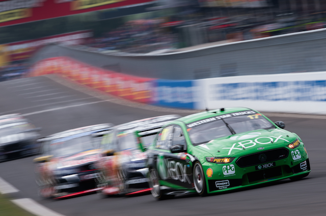 The Scott Pye/Marcos Ambrose DJR Team Penske Ford leads the Red Bulls into Hell Corner