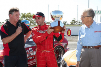Ricciardello receiving the 2014 Clem Smith trophy from its namesake (right) and commentator Garry O'Brien