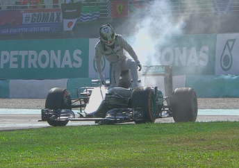 Lewis Hamilton climbs from his car after an engine failure in Sepang pic: F1 Twitter